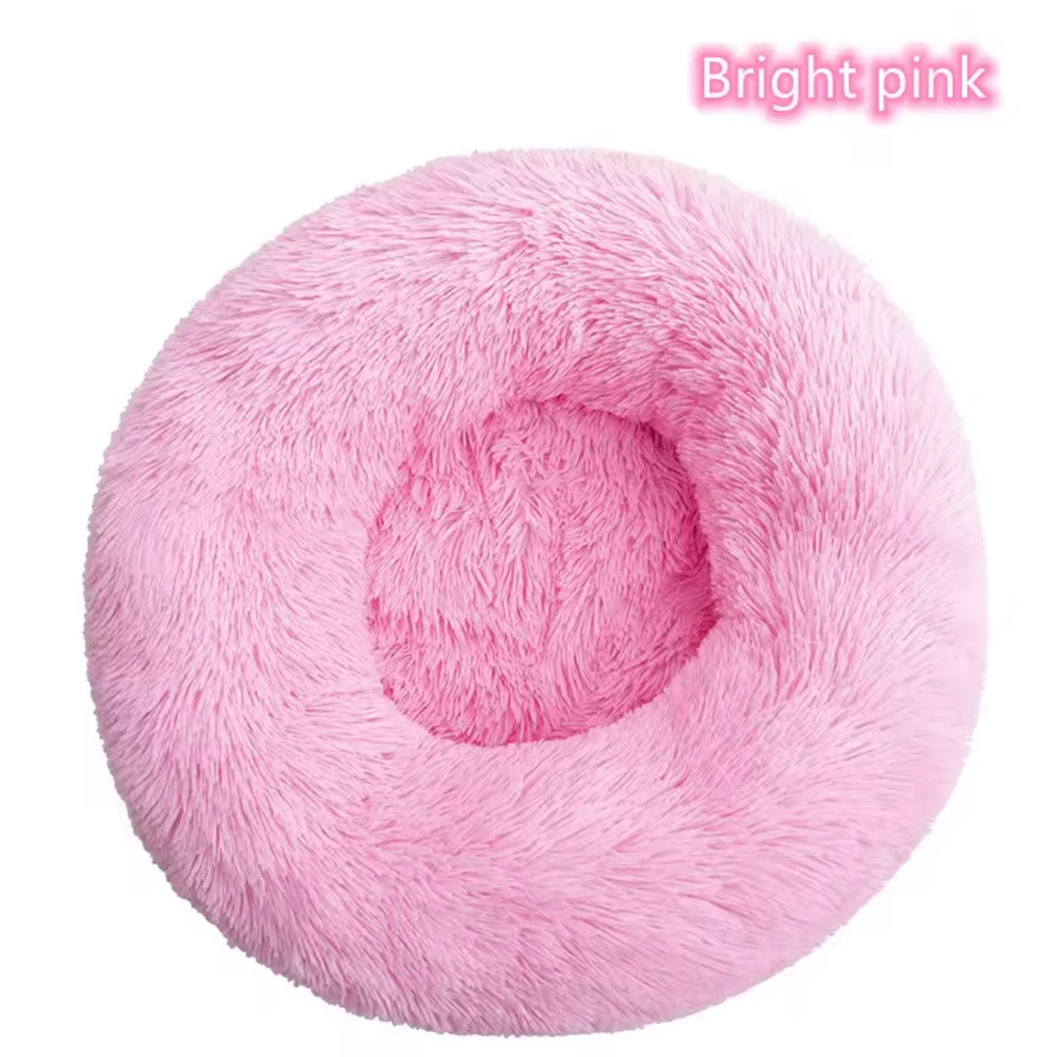 "Calming donut dog bed in bright pink– front view"